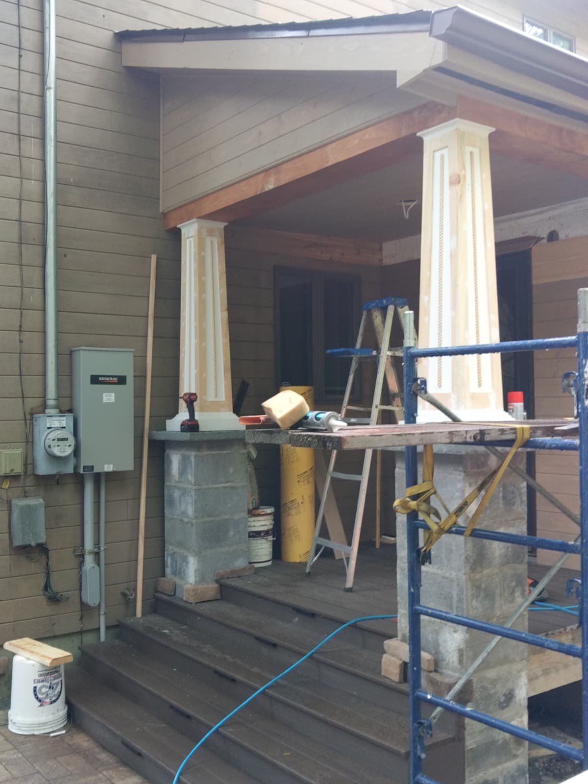 Covered porch construction with new columns and roof structure