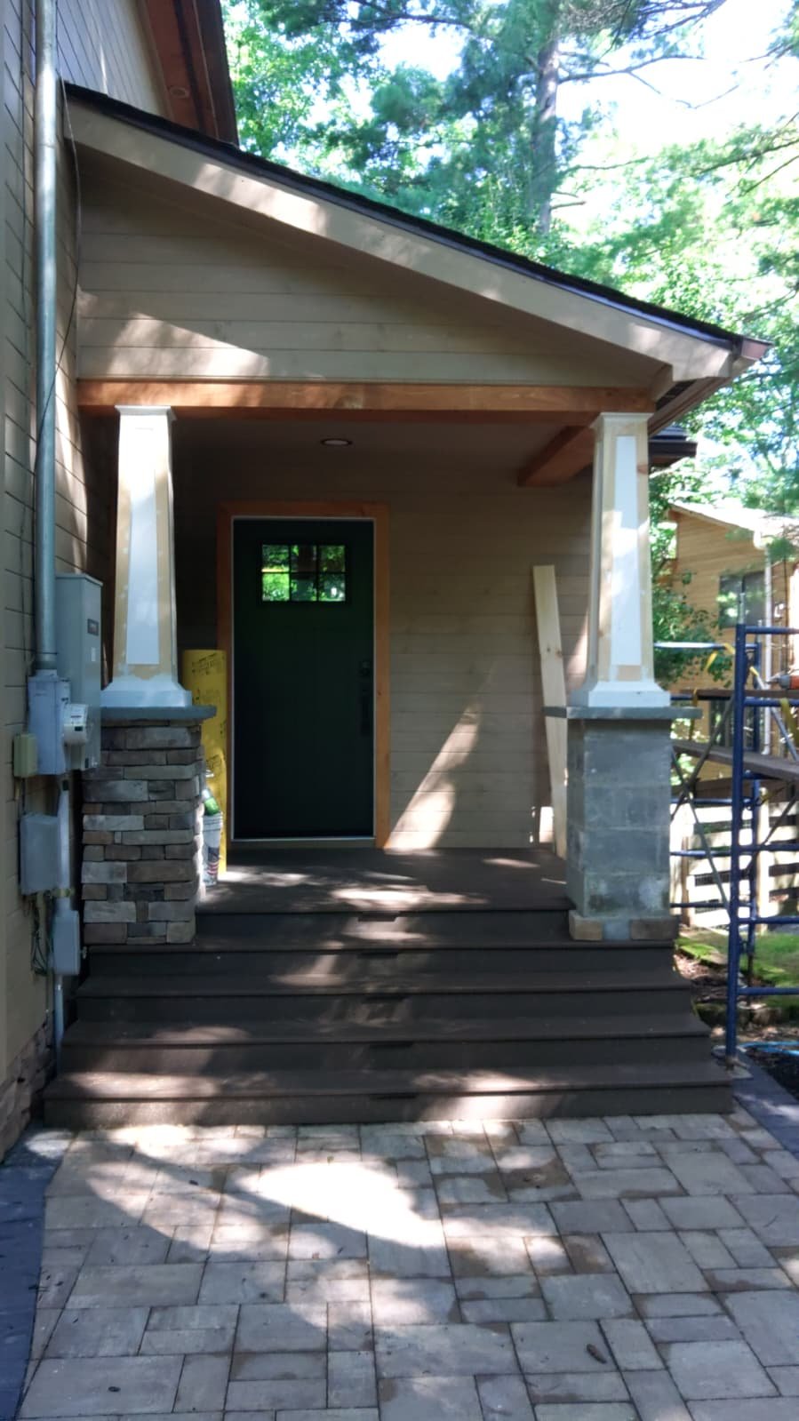 Completed front porch with deck steps and stone columns